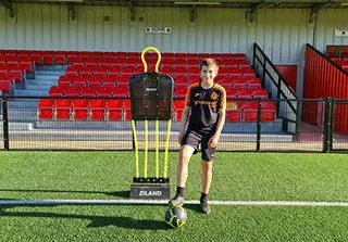 boy with orange and black kit