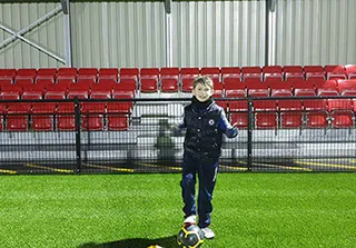 boy with ball and coat
